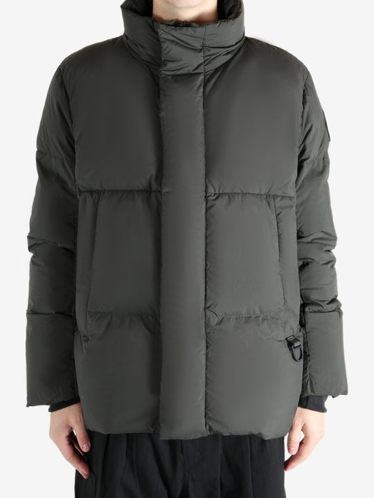 Green jacket worn by a person, showing the coat's fit