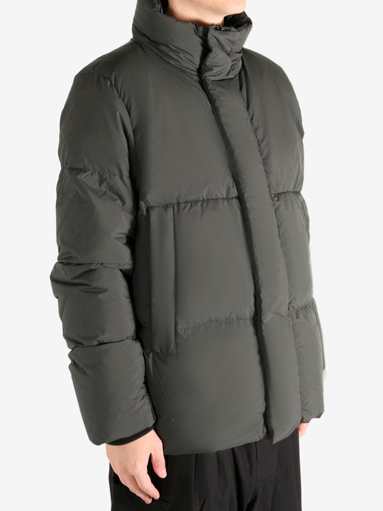 Green jacket worn by a person, showing the coat's fit