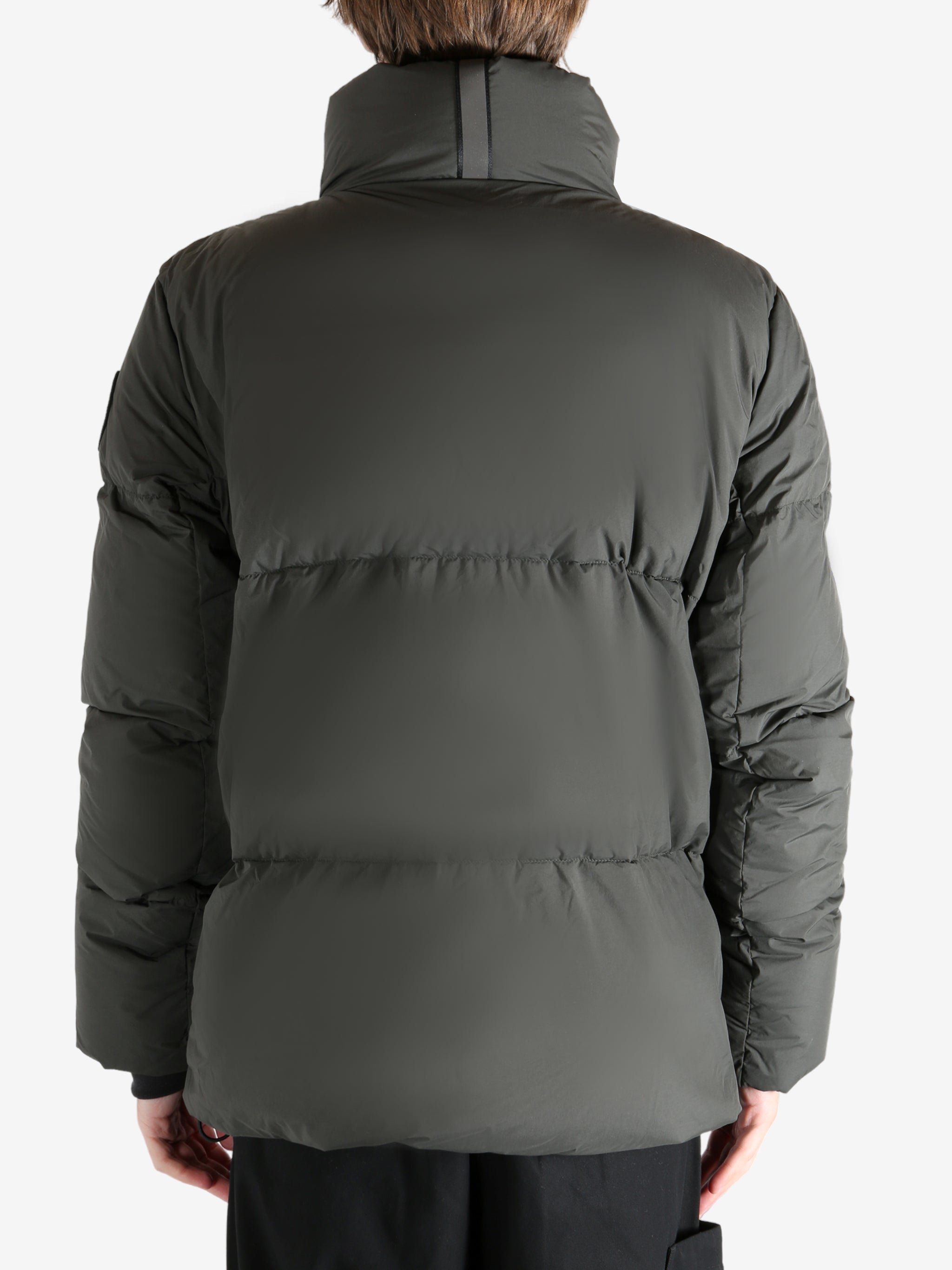 Green jacket worn by a person, showing the coat's fit