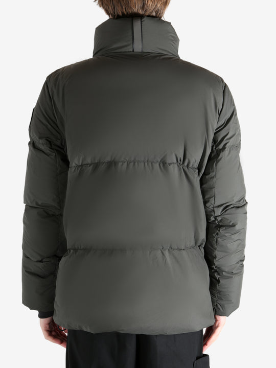 Green jacket worn by a person, showing the coat's fit