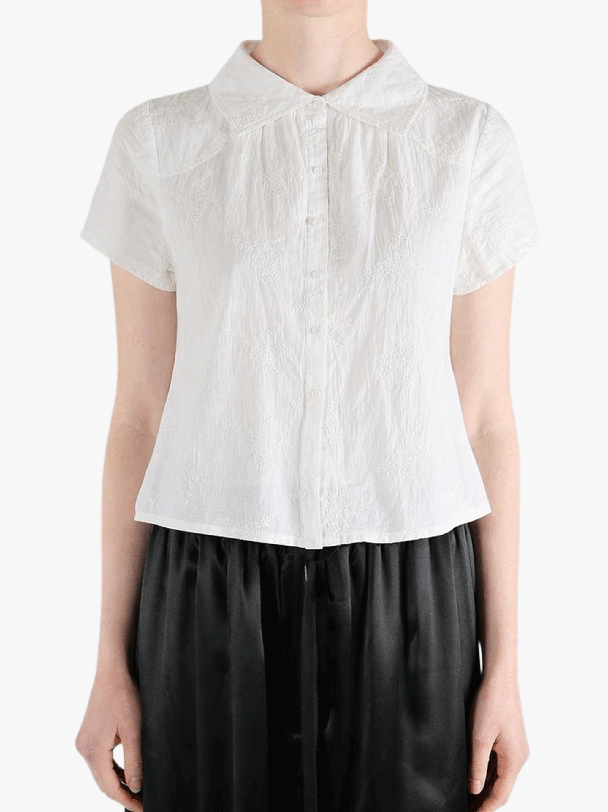 White top worn by a person, showing the top's fit