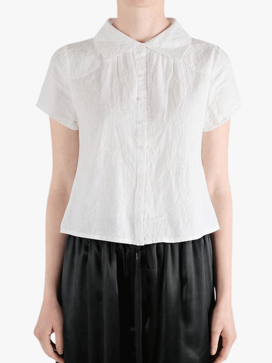 White top worn by a person, showing the top's fit