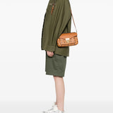 Orange bags worn by a person, showing the bag's fit