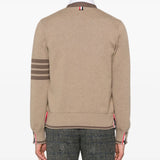 Brown knitwear worn by a person, showing the knitwear's fit