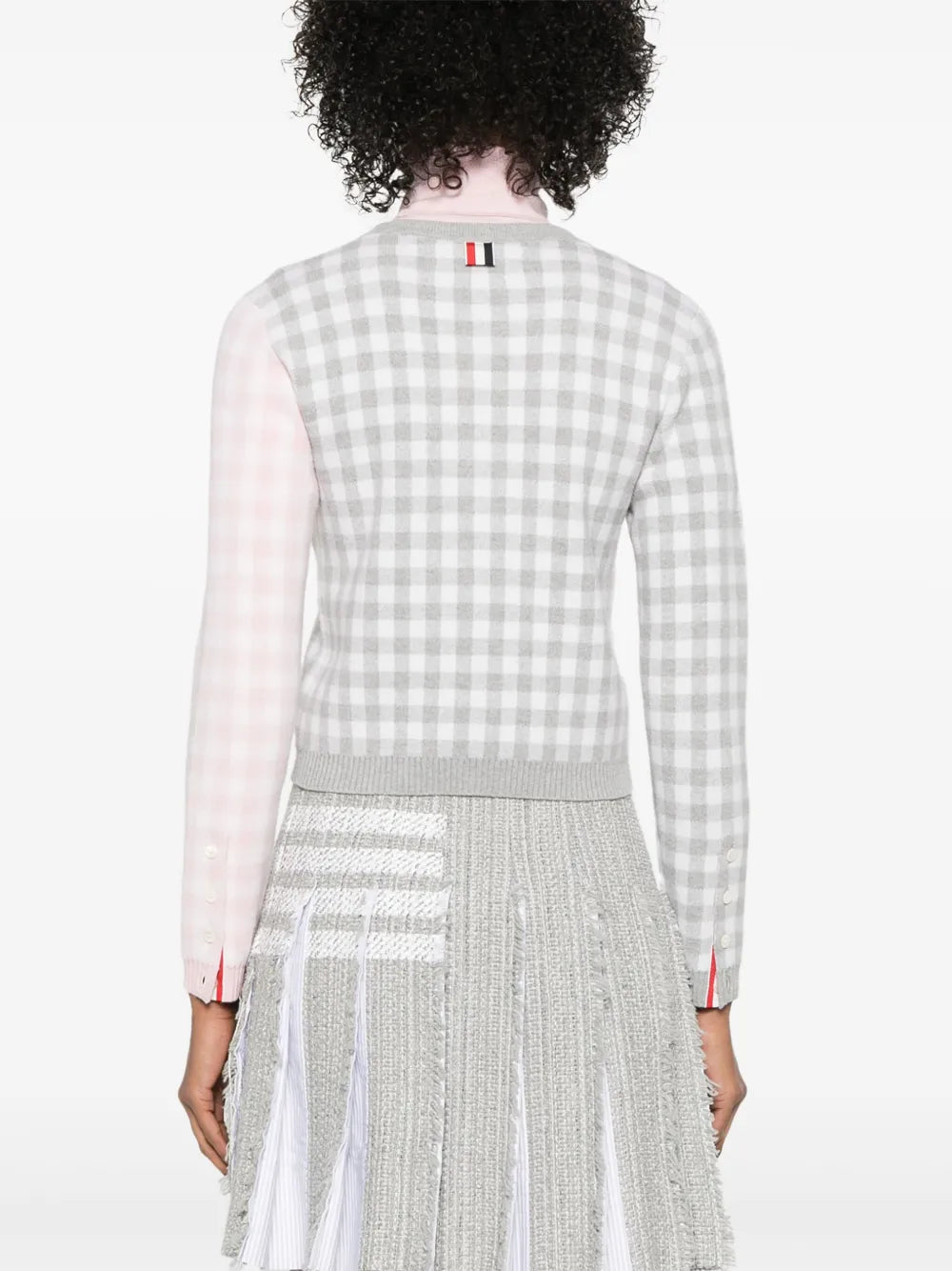 Grey knitwear worn by a person, showing the knitwear's fit