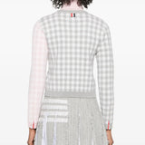 Grey knitwear worn by a person, showing the knitwear's fit