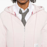 Pink hoodie worn by a person, showing the hoodie's fit