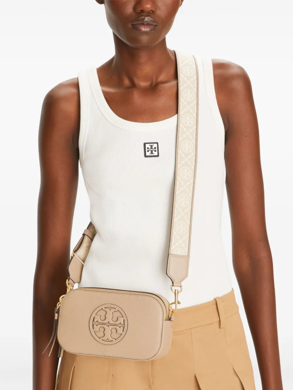 Tan bag worn by a person, showing the bag's fit