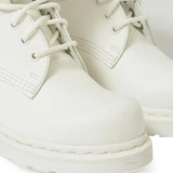 Close up of the white boots, showing texture of the rubber and leather fabric