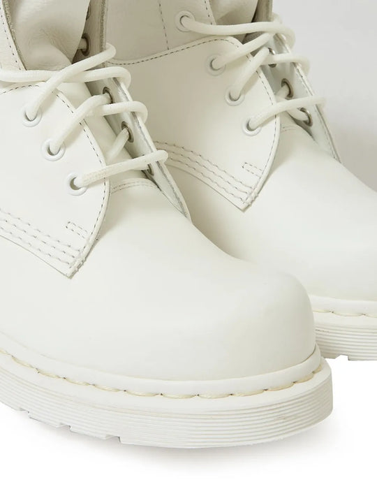 Close up of the white boots, showing texture of the rubber and leather fabric