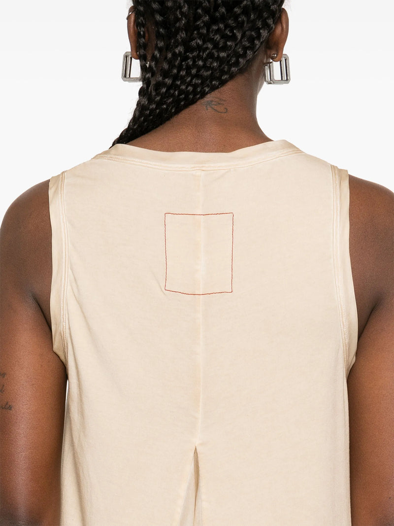 Close up of beige sleeveless dress, showing texture of the silk fabric