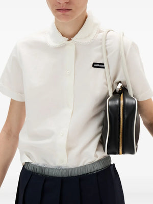 White shirt worn by a person, showing the shirt's fit