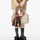 Tan bag worn by a person, showing the  bag's fit