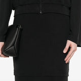 Close up of black midi skirt, showing texture of the cupro fabric