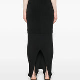 Black midi skirt worn by a person, showing the skirt  fit