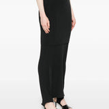 Black midi skirt worn by a person, showing the skirt  fit