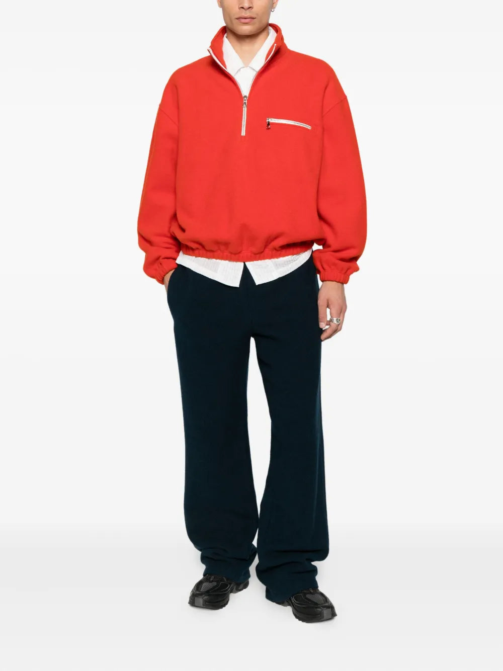 Orange knitwear worn by a person, showing the knitwear's fit