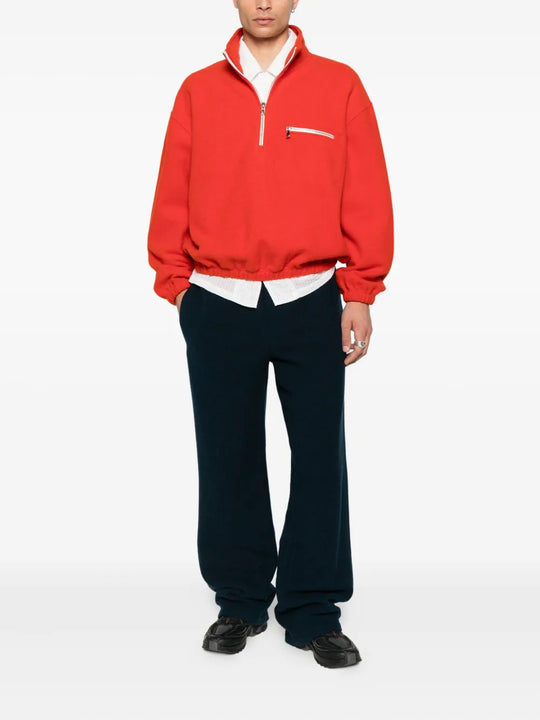 Orange knitwear worn by a person, showing the knitwear's fit