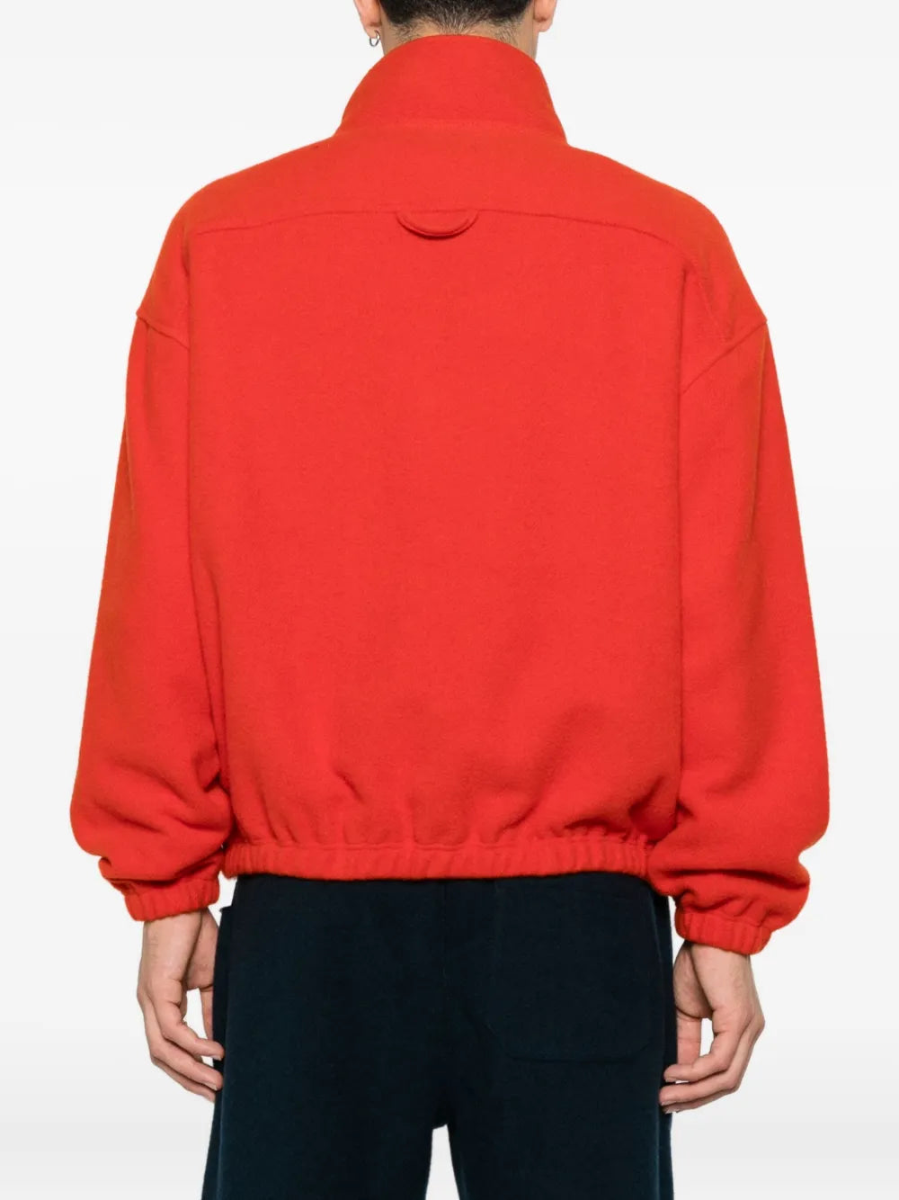 Orange knitwear worn by a person, showing the knitwear's fit