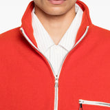 Close up of orange knitwear, showing texture of the wool fabric