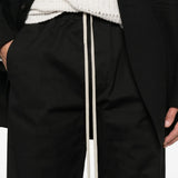Close up of the black pants, showing texture of the cotton fabric
