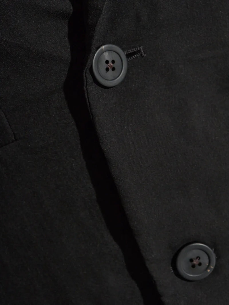 Close up of black coat,showing texture of the silk fabric.