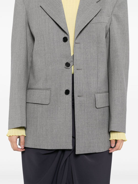 Grey jacket worn by a person, showing the jacket's fit