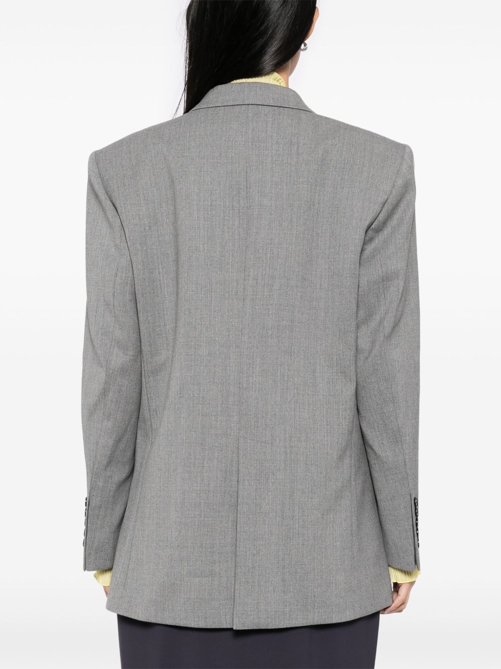 Grey jacket worn by a person, showing the jacket's fit