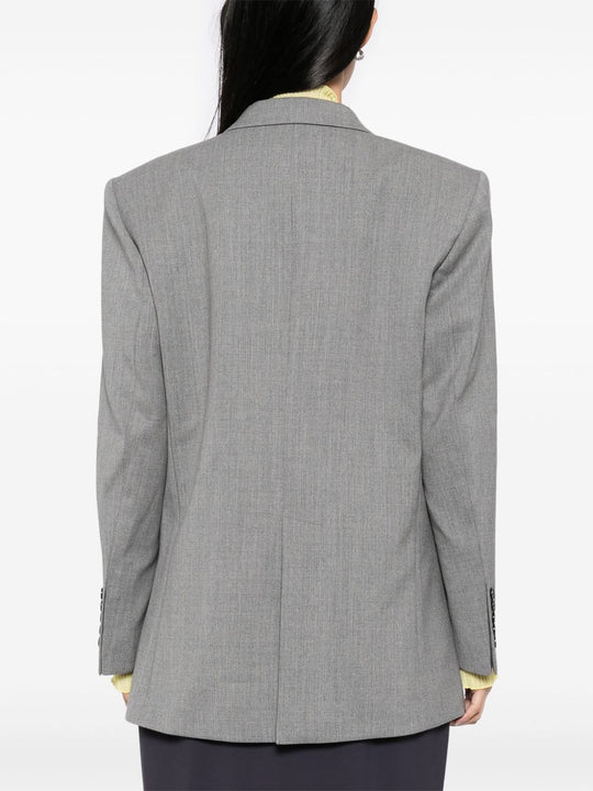 Grey jacket worn by a person, showing the jacket's fit