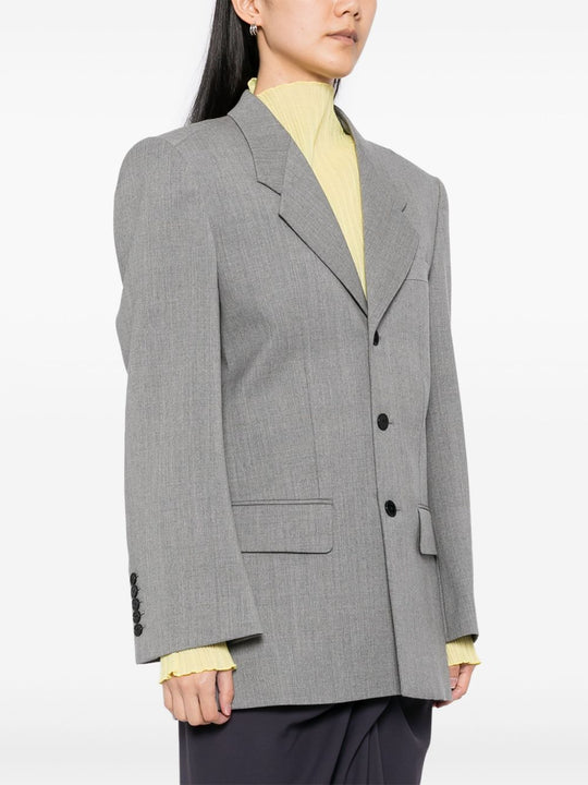 Grey jacket worn by a person, showing the jacket's fit