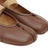 Close up of the brown flats, showing texture of the leather fabric