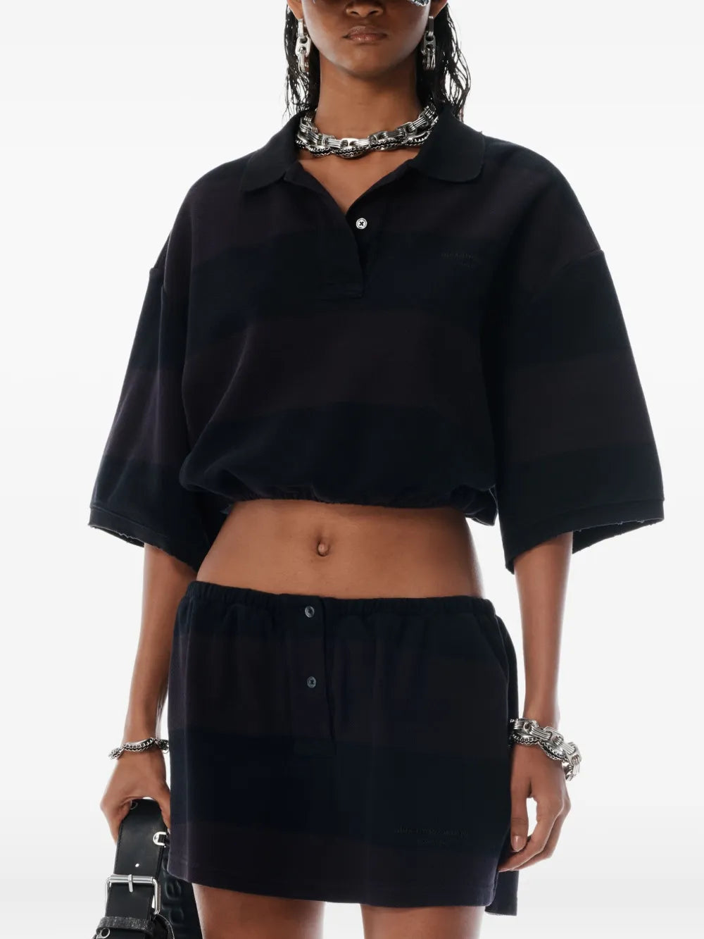 Black shirt worn by a person, showing the shirt's fit