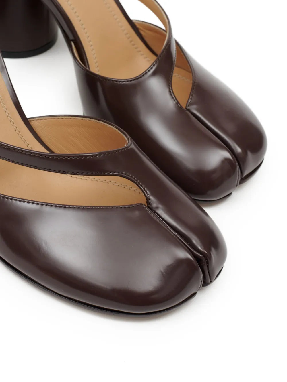 Close up of the brown sandal, showing texture of the leather fabric
