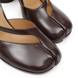 Close up of the brown sandal, showing texture of the leather fabric