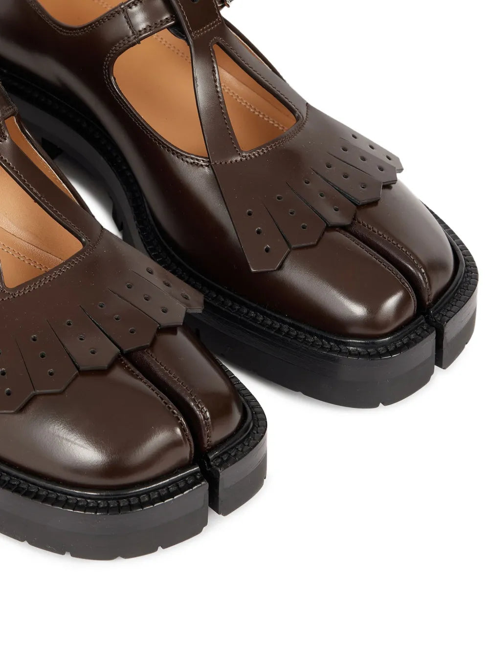 Close up of the brown shoes, showing texture of the leather fabric