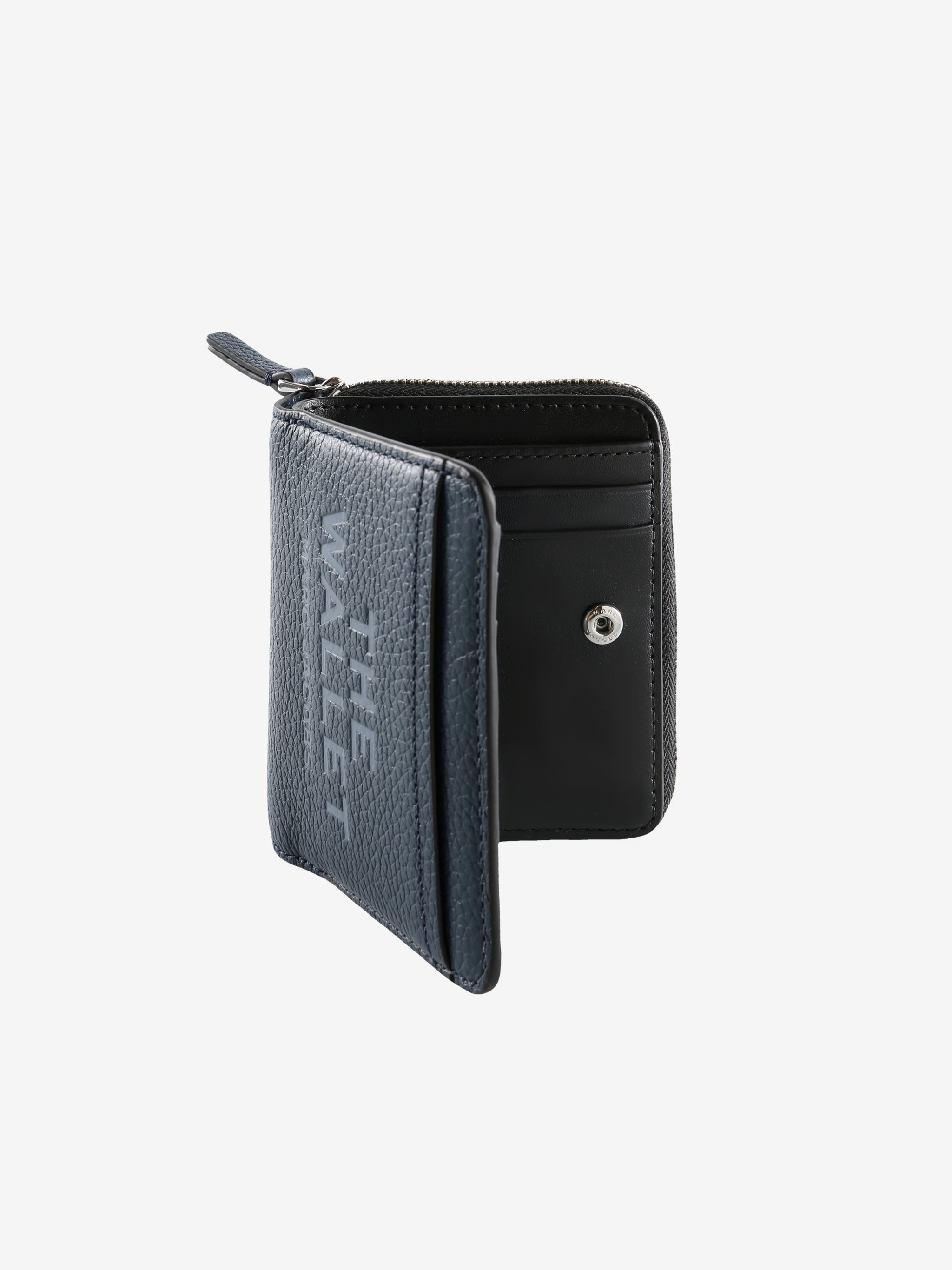 Close up of navy wallet, showing texture of the leather fabric