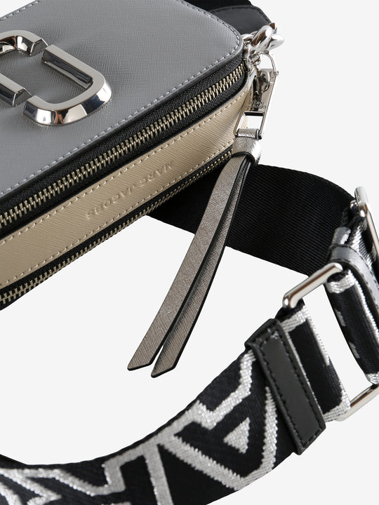 Close up of grey bag, showing texture of the leather fabric