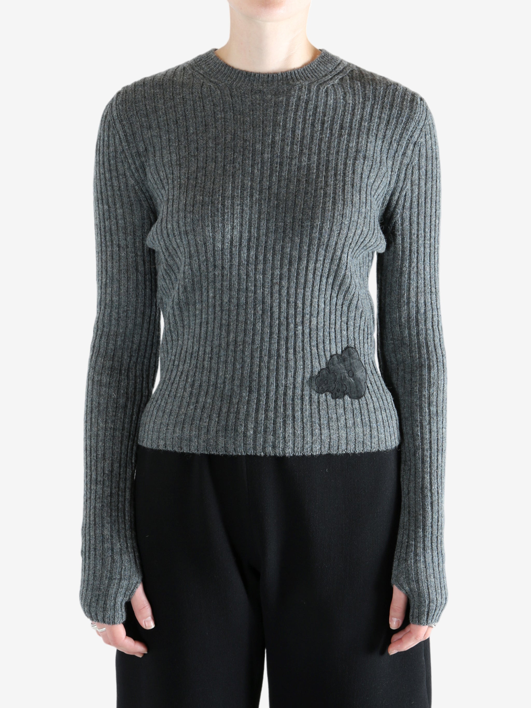 Grey sweat  worn by a person, showing the sweat's fit