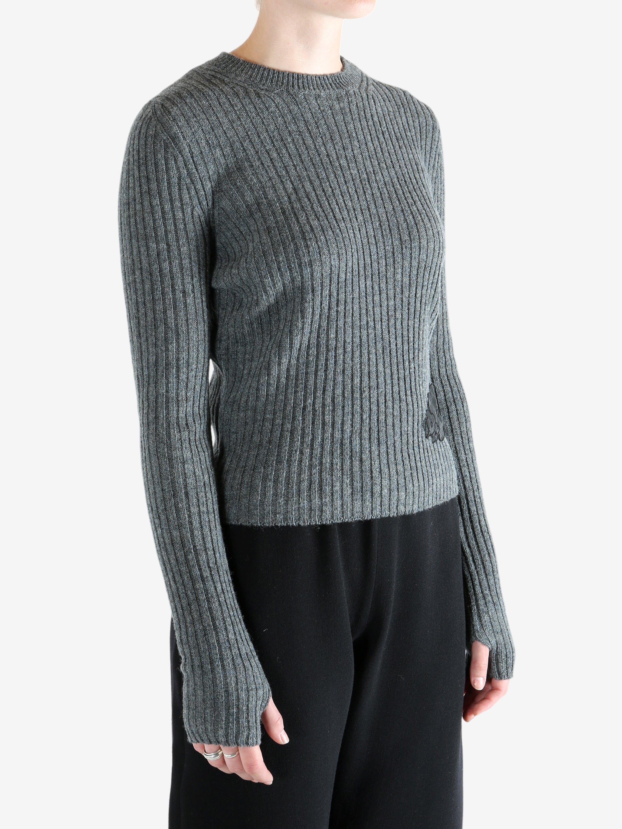 Grey sweat  worn by a person, showing the sweat's fit