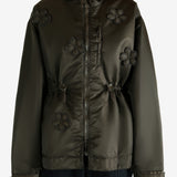 Green jacket worn by a person, showing the jacket's fit