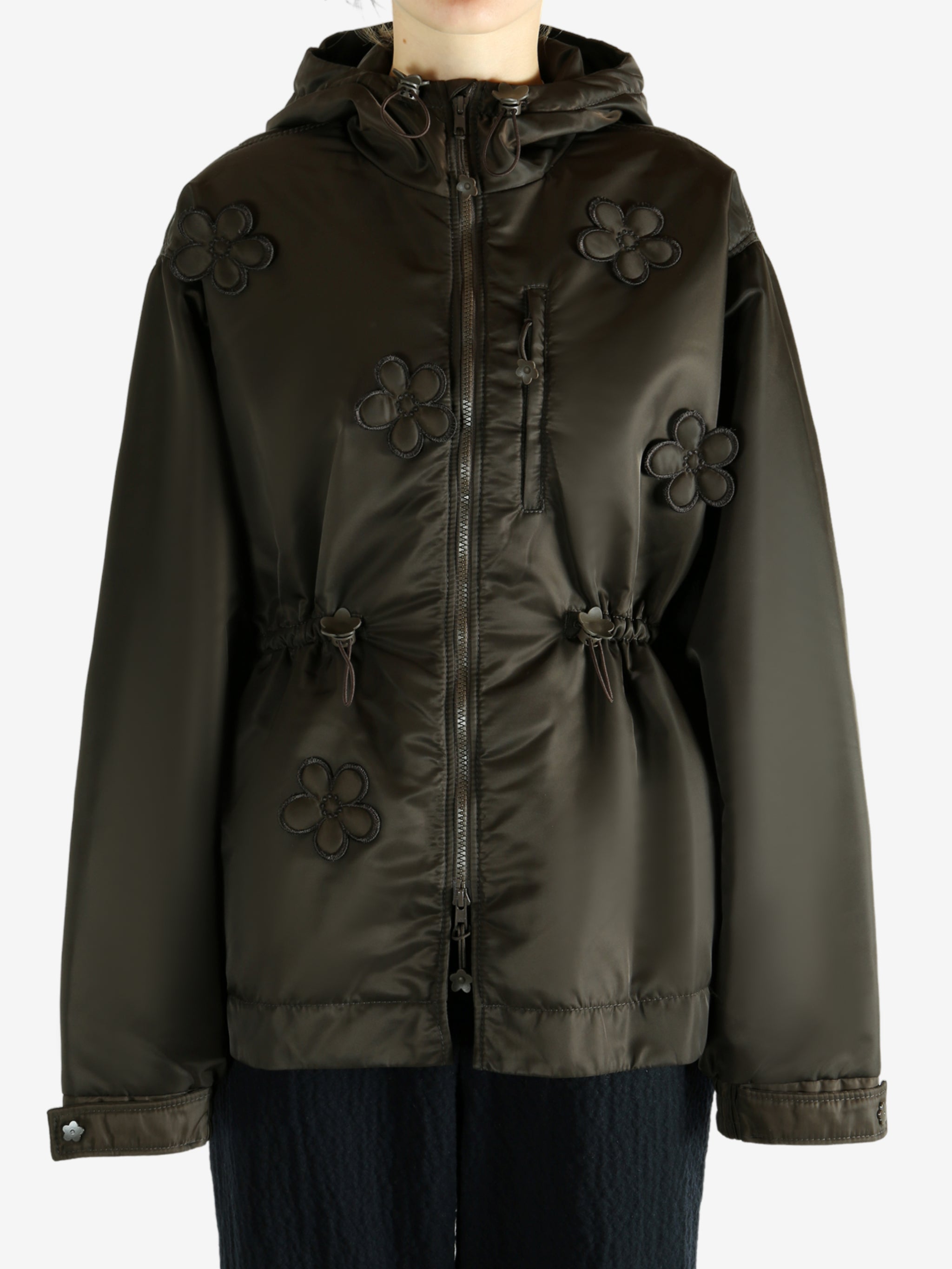 Green jacket worn by a person, showing the jacket's fit