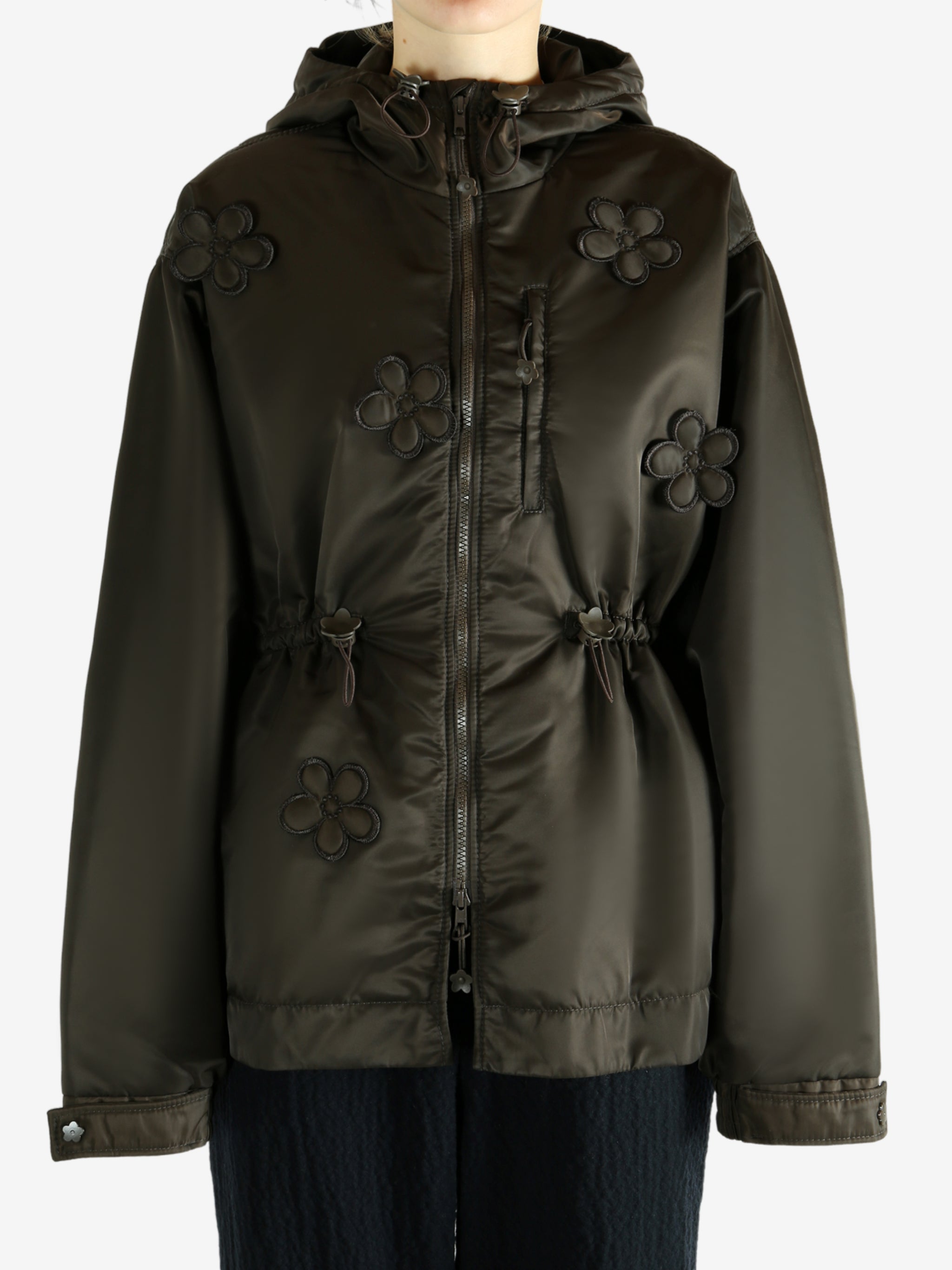 Green jacket worn by a person, showing the jacket's fit