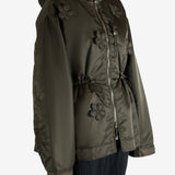 Green jacket worn by a person, showing the jacket's fit