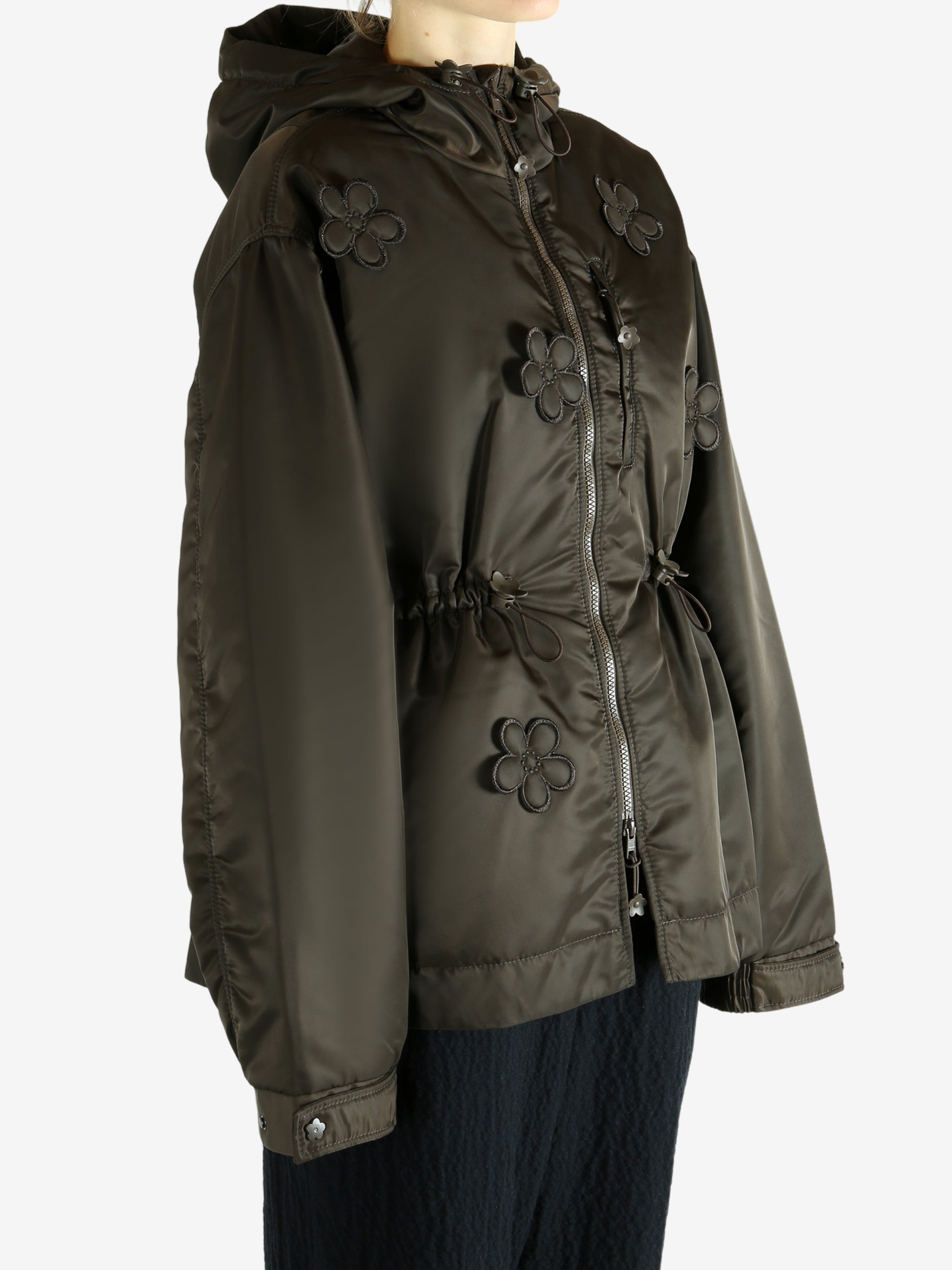 Green jacket worn by a person, showing the jacket's fit