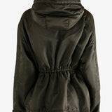 Green jacket worn by a person, showing the jacket's fit