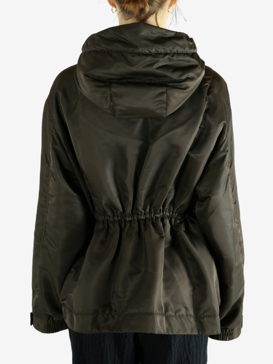 Green jacket worn by a person, showing the jacket's fit