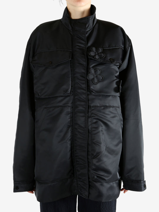 Black jacket worn by a person, showing the jacket's fit