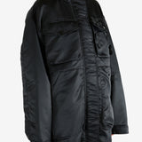 Black jacket worn by a person, showing the jacket's fit