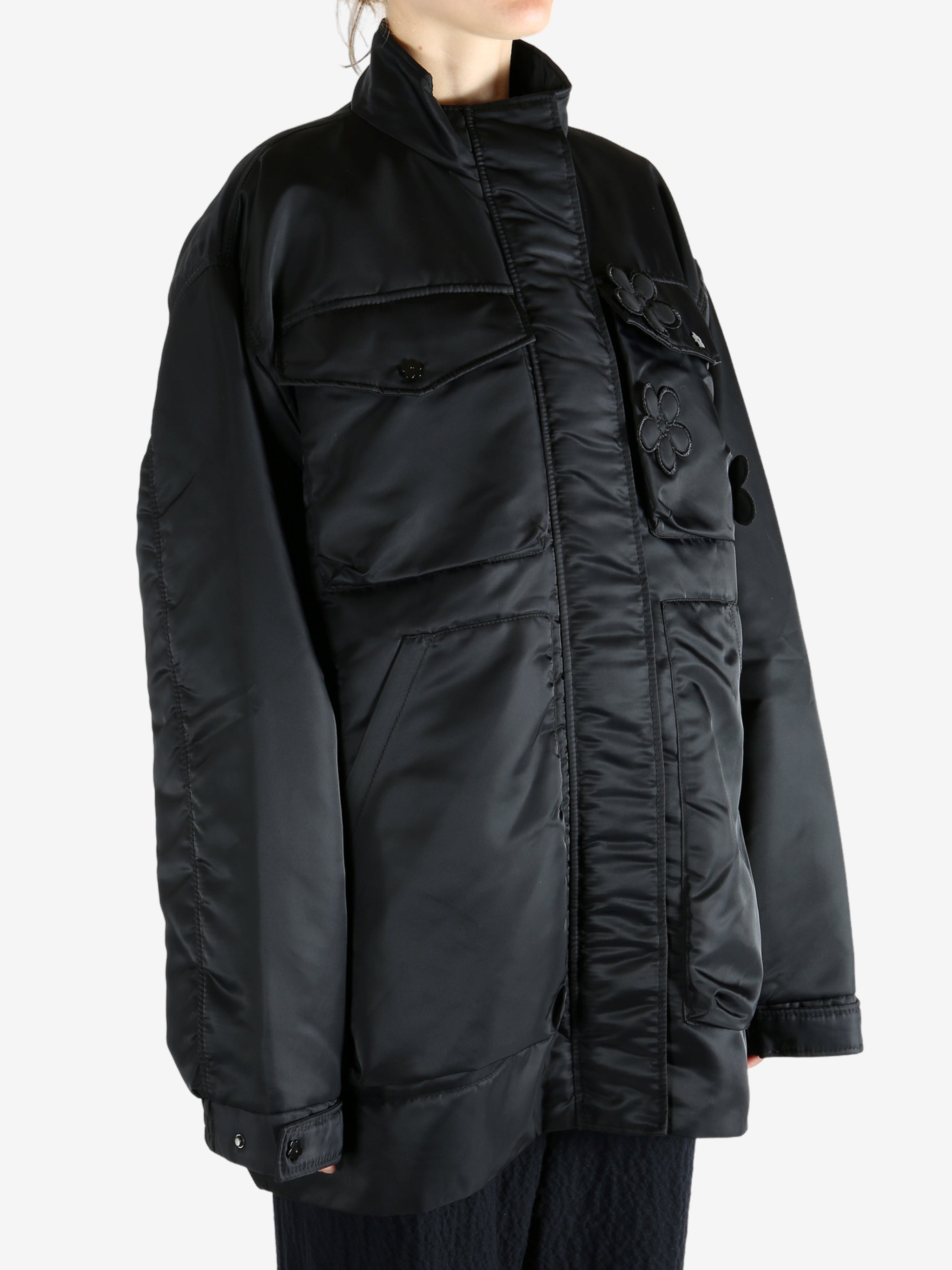 Black jacket worn by a person, showing the jacket's fit