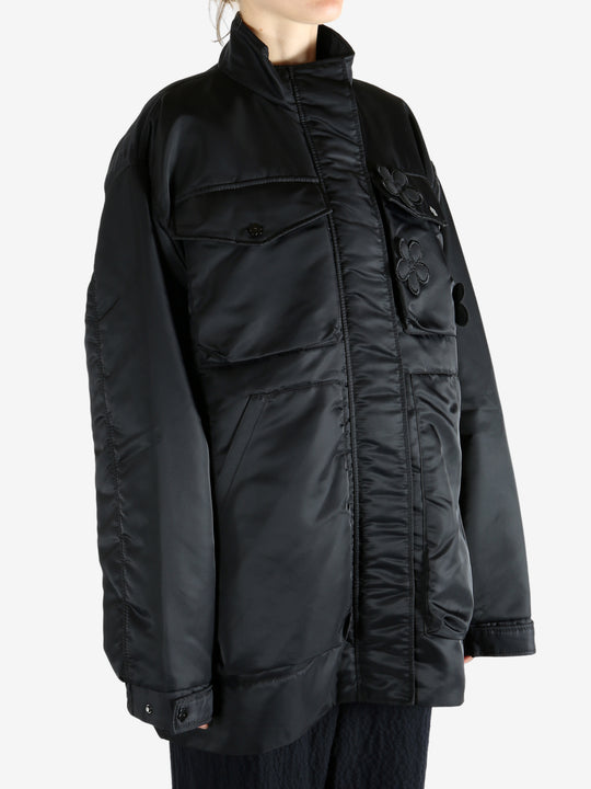 Black jacket worn by a person, showing the jacket's fit